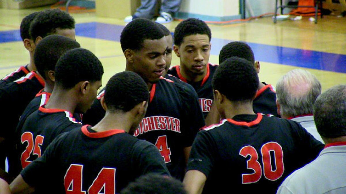 Westchester basketball team surrounds Coach Ed Azzam during game against Palisades.