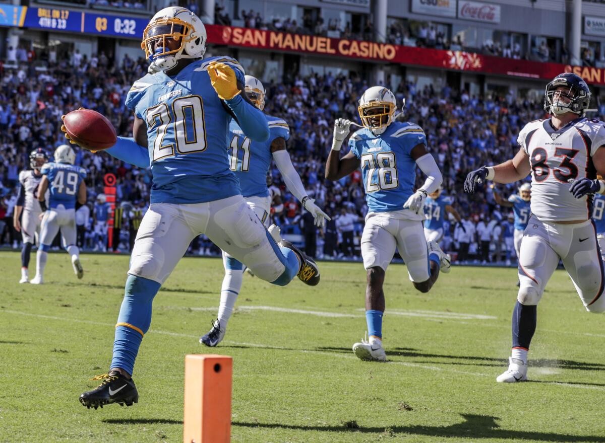 Chargers defensive back Desmond King (20) scores on a 68-yard punt return during third quarter against the Denver Broncos at Dignity Health Sports Park on Oct. 6.