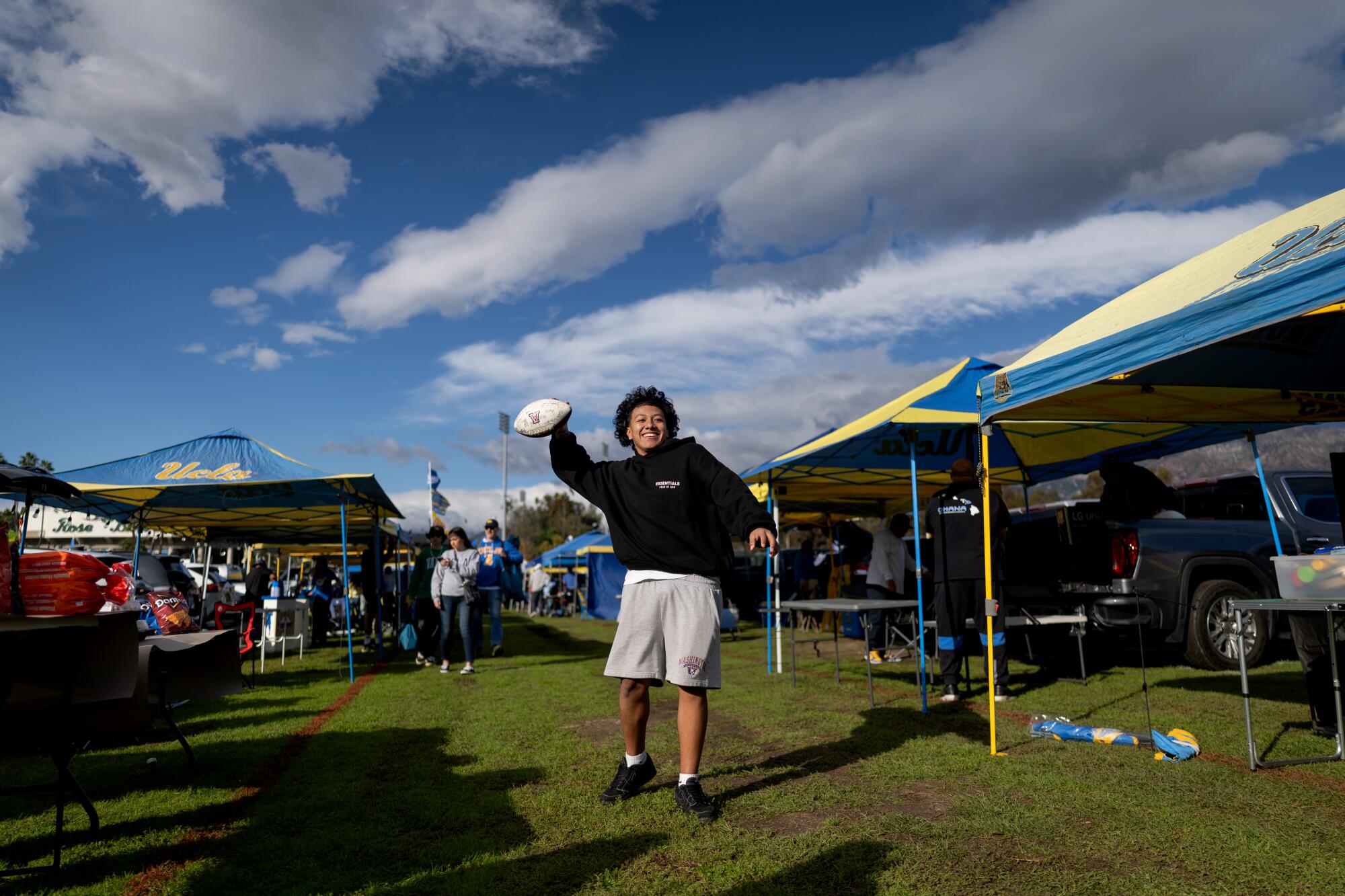 UCLA followers tailgating at Rose Bowl apprehensive about doable transfer to SoFi Stadium 2 UCLA fan Leki Manu throws a football outside the Rose Bowl before Saturday's game against Washington.