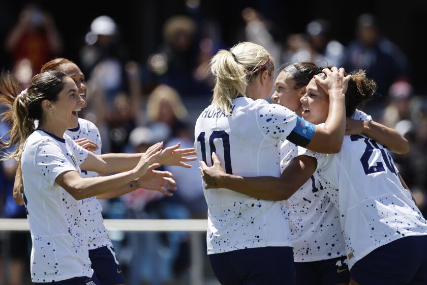 U.S. players Lindsey Horan and Sophia Smith hug and celebrate with Trinity Rodman after she scored