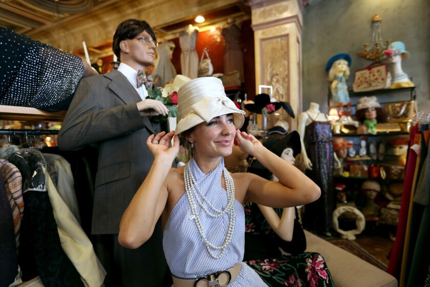 Alex Wilson, 35 of Los Angeles, tries on a vintage hat at Playclothes Vintage, in Burbank.