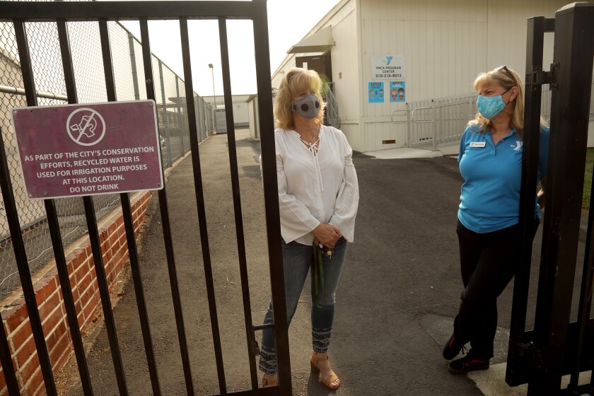L.A. schools are closed — but there are loopholes for those
with money 4 Anza Elementary School Principal Barbara Marks and Sharon Drobka, associate executive director with the YMCA
