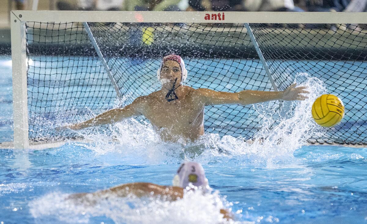 Newport Harbor's Cooper Mathisrud makes a save against Mater Dei during Wednesday night's match.