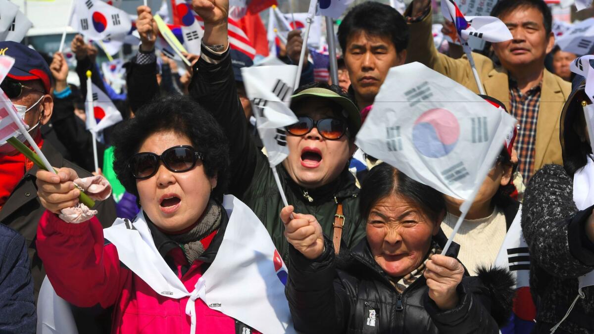 Supporters of South Korea's impeached ex-president, Park Geun-hye, rally in Seoul on Saturday to demand a repeal of her impeachment.