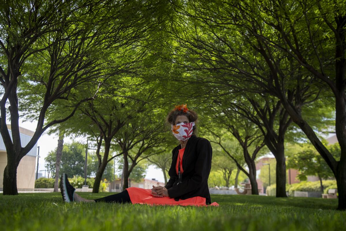  Activist Albia Miller sits  under a canopy of shade trees at the Menifee Valley campus of Mt. San Jacinto College