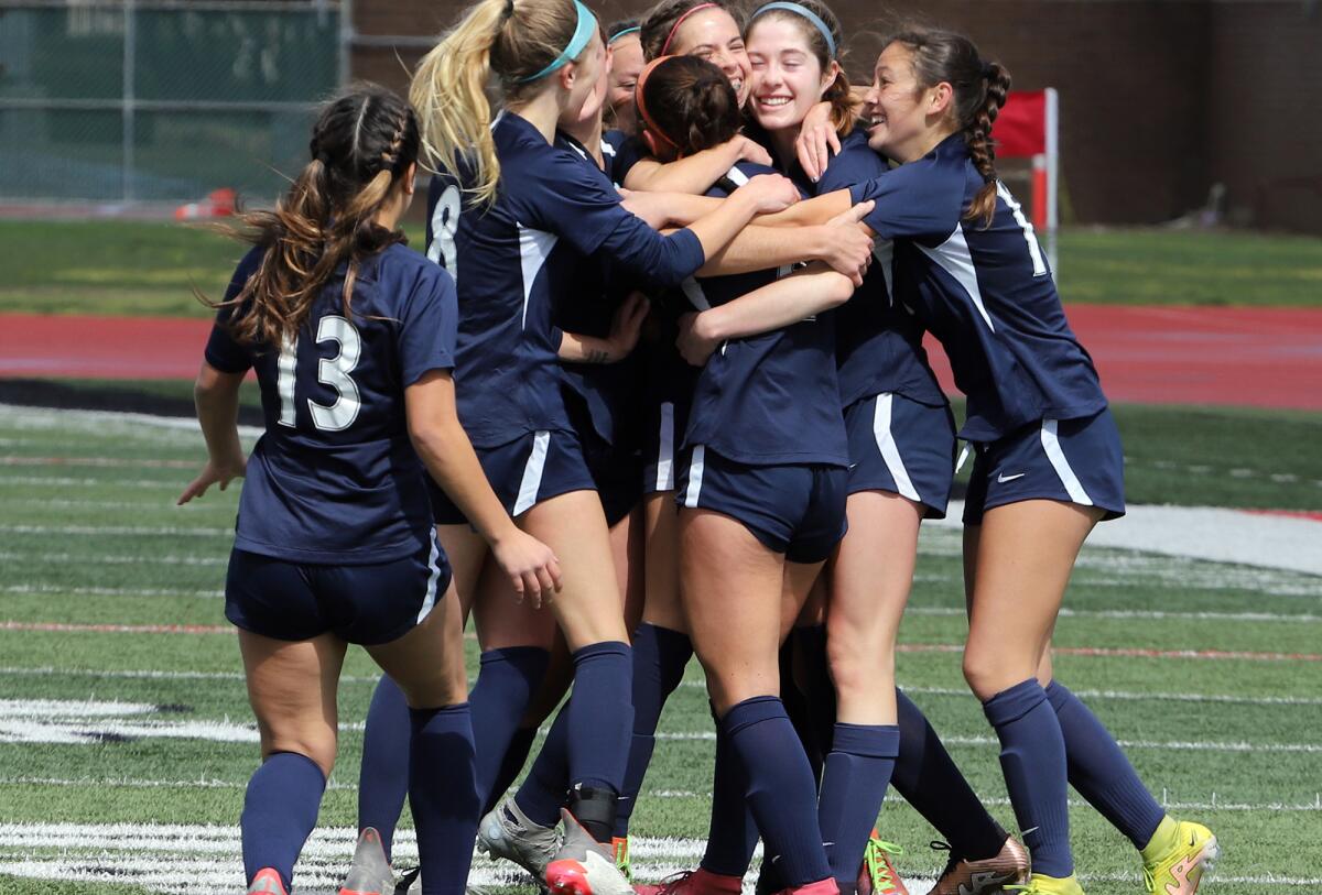 Marina's girls' soccer players celebrate after Riley Crosby scored a goal to tie Saturday's match.