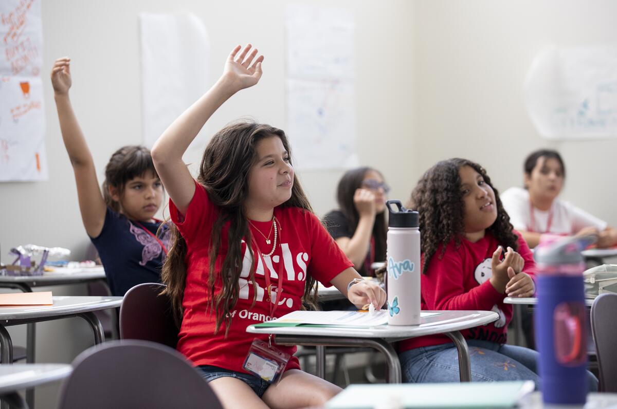 Ava Tang raises her hand during a lesson on sales pitches during Smart Ups.