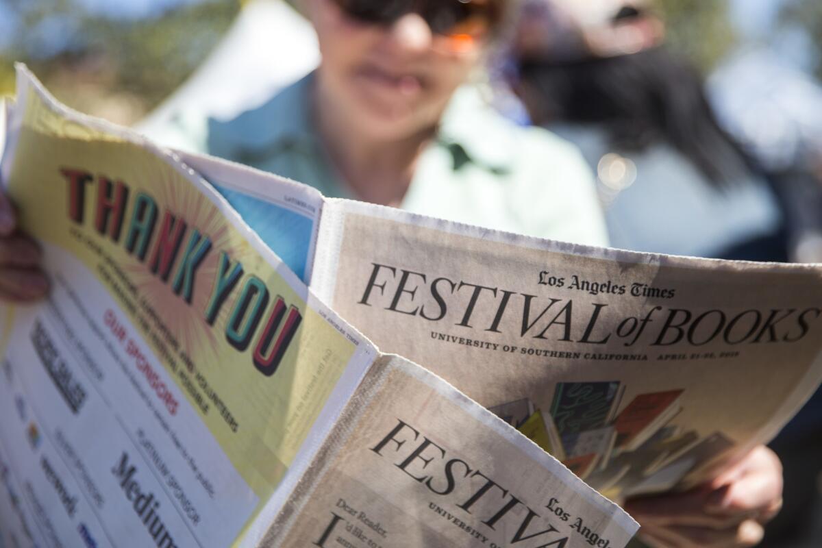 Linda Arkin, 75, of Valencia, looks over the Festival of Books section of the Los Angeles Times on April 21, 2018.