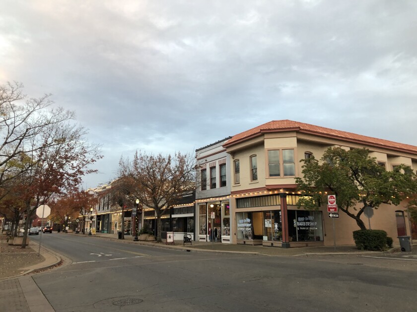 A street of businesses at dusk.