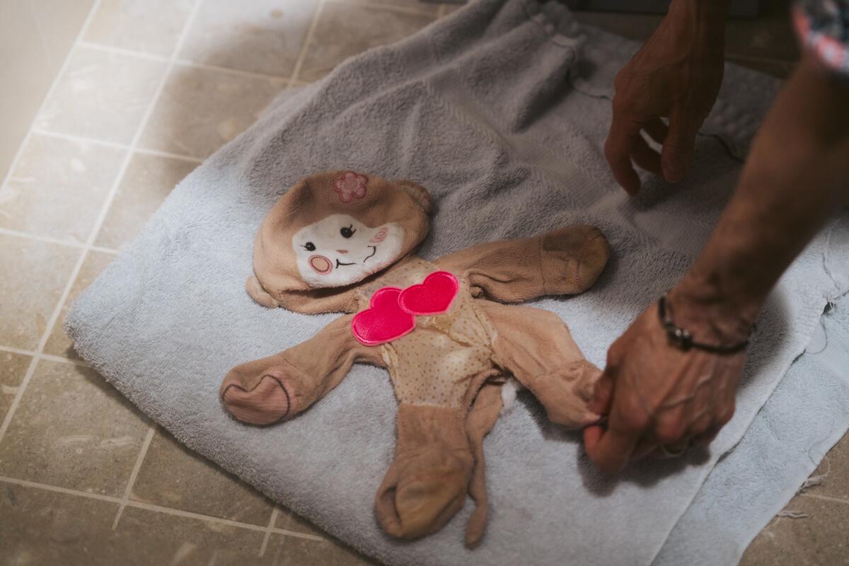 A toy minus its stuffiing is towel-dried.