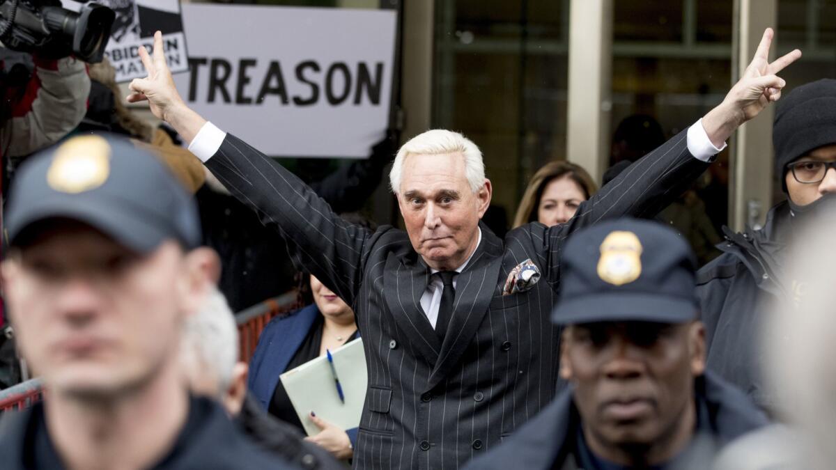 Roger Stone in February 2019 lifting his arms in a victory salute after earlier pleading not guilty to several charges. 