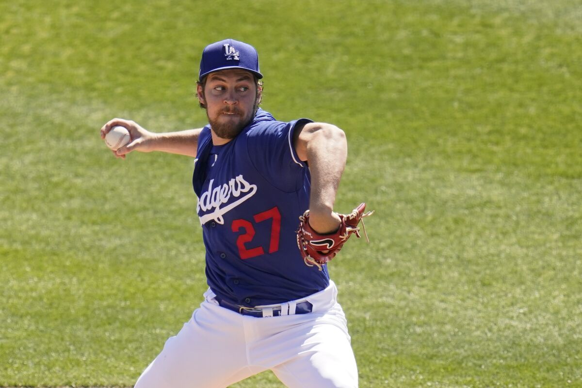 A man in a blue Dodgers uniform wearing the number 27 throws a baseball 