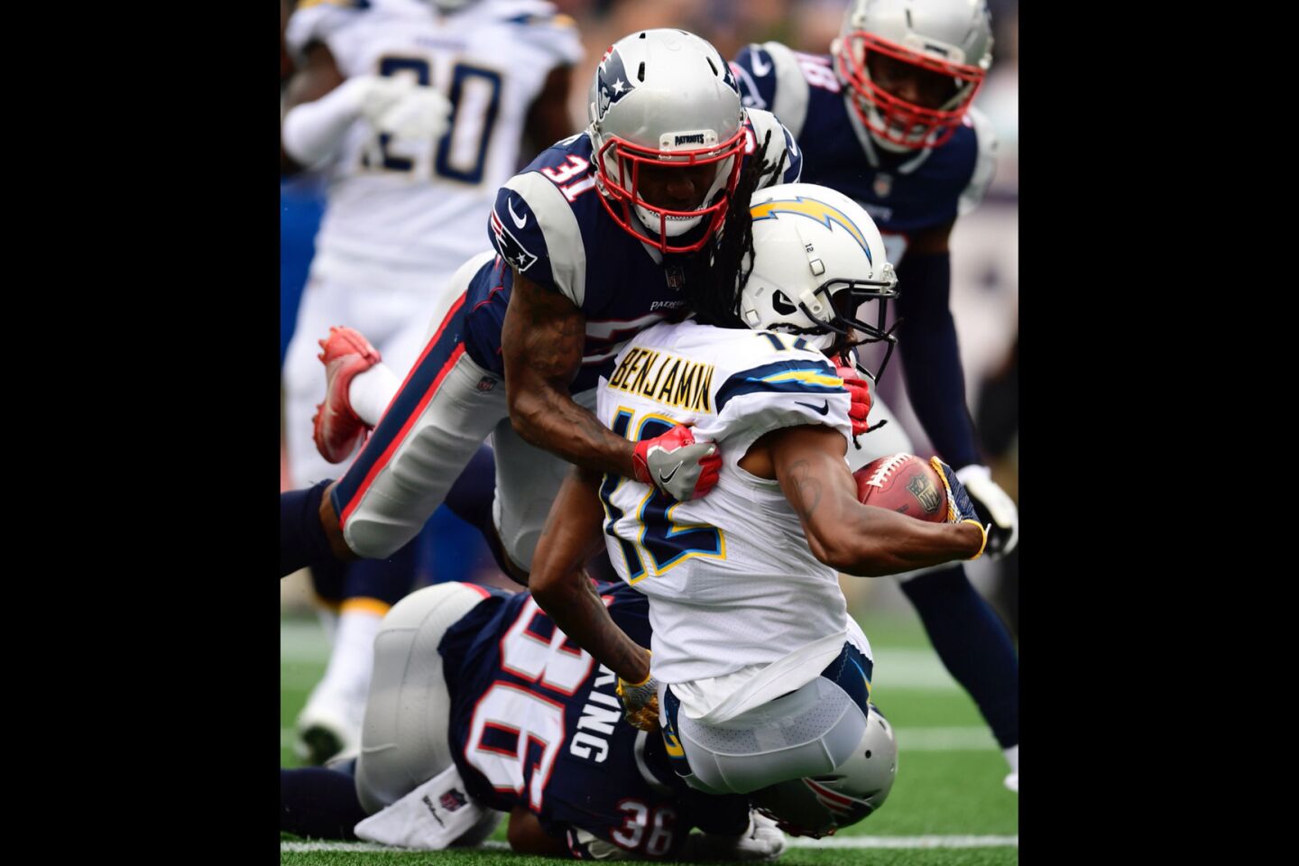 New England Patriots defensive back Brandon King (L) and New England Patriots cornerback Jonathan Jones (C) tackle Los Angeles Chargers wide receiver Travis Benjamin (R) in the end zone for a safety.