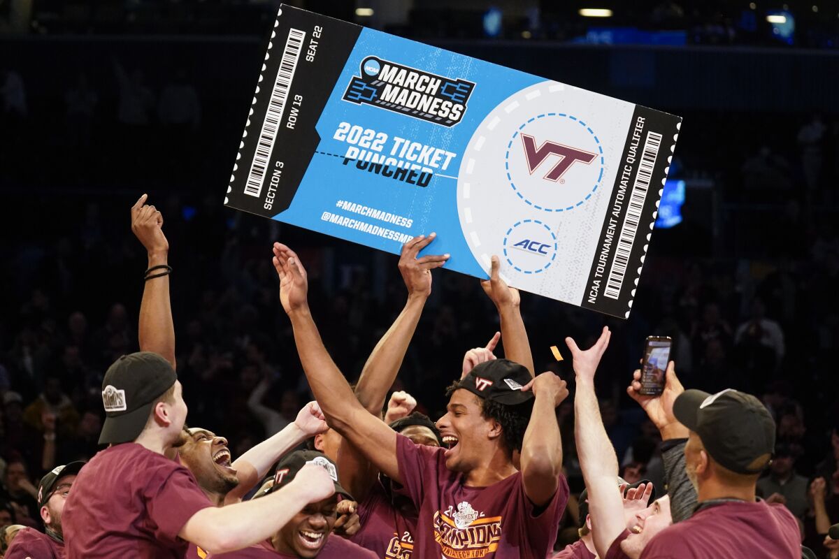 Virginia Tech celebrates after winning the NCAA college basketball championship game against Duke in the Atlantic Coast Conference men's tournament, Saturday, March 12, 2022, in New York. Virginia Tech won, 82-67. (AP Photo/John Minchillo)