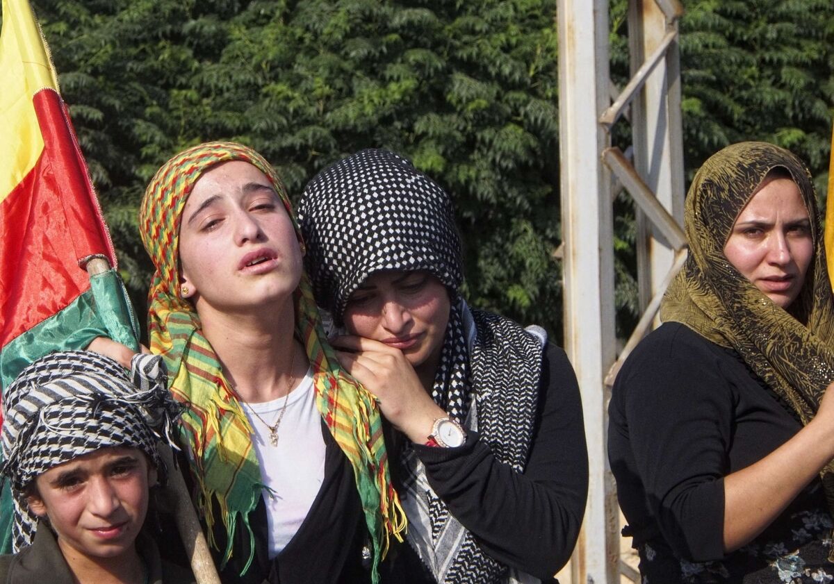 Mourners attend a Kurdish funeral in northern Syria, where the Kurds declared their own autonomous region in July.
