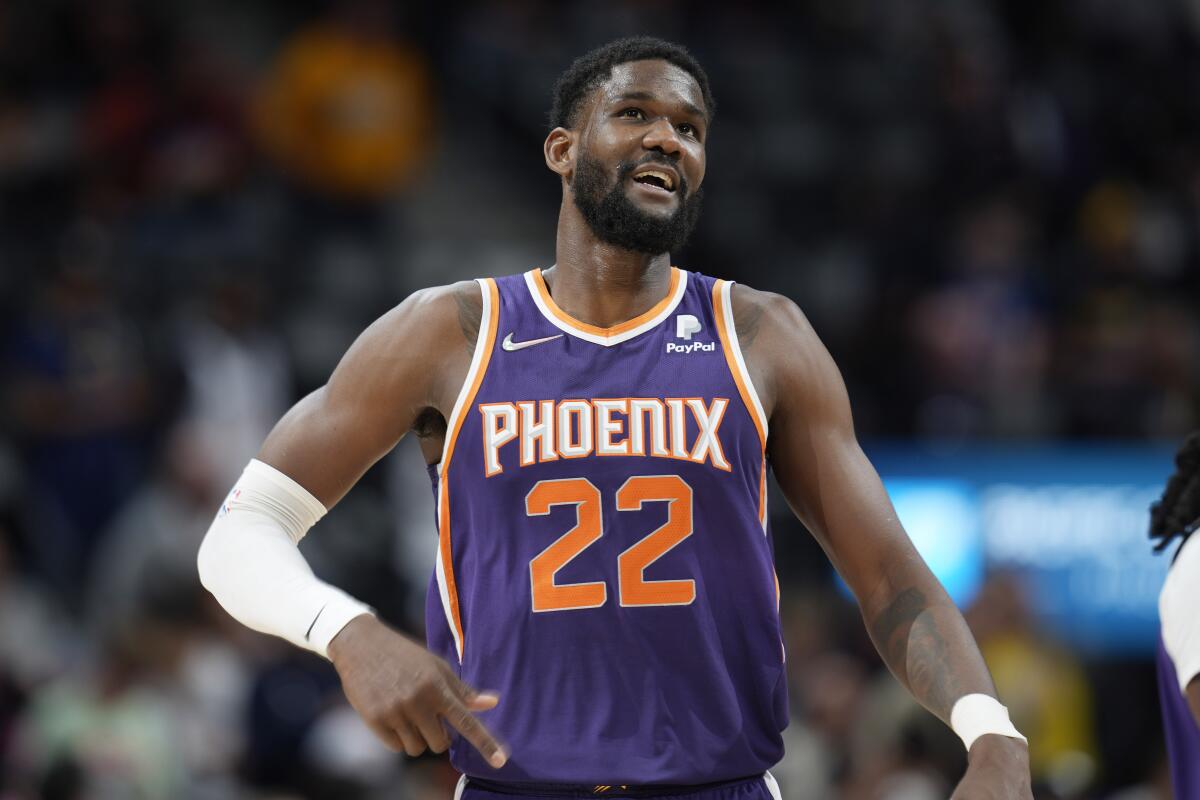 FILE - Phoenix Suns center Deandre Ayton looks on during the second half of an NBA basketball game on March 24, 2022, in Denver. The Indiana Pacers have signed restricted free agent Deandre Ayton to a four-year, $133 million offer sheet Thursday, July 14, 2022. Phoenix now has two days to match the offer — or lose the center it selected with the top overall pick in the 2018 NBA draft. (AP Photo/David Zalubowski, File)