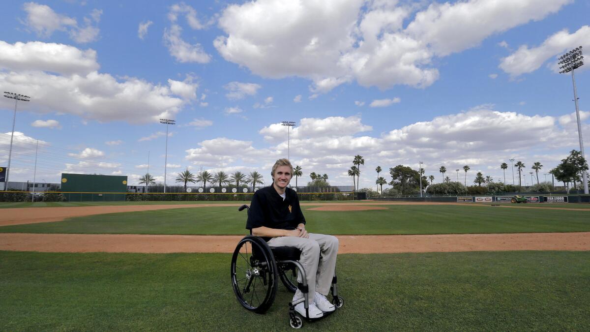 Cory Hahn poses in front of Arizona State's Packard Stadium, where he suffered a devastating injury in his third collegiate game that left him paralyzed from the chest down. Hahn has come a long way since the injury.