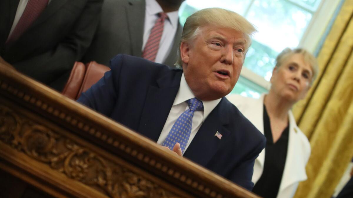 President Trump speaks to reporters about Mexico in the Oval Office at the White House in Washington on June 25.