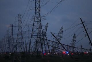 Transmission power lines are down near the Grand Parkway and West Road after a storm Thursday, May 16, 2024, in Cypress, Texas. (Melissa Phillip/Houston Chronicle via AP)