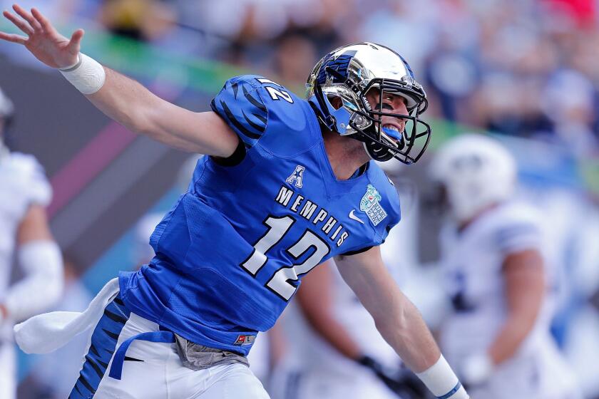 Memphis quarterback Paxton Lynch celebrates after throwing a touchdown pass during the first quarter of a 55-48 double-overtime win against Brigham Young in the Miami Beach Bowl on Monday.