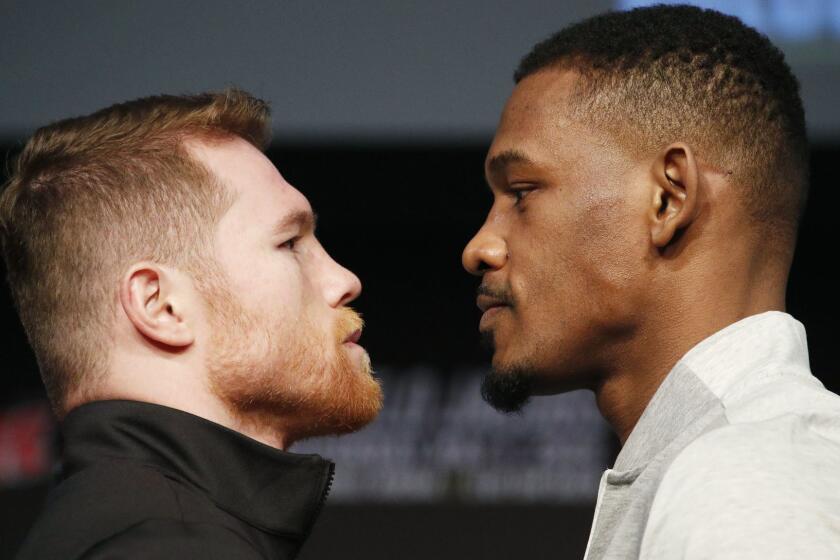 Canelo Alvarez, left, and Daniel Jacobs pose for photographers at a news conference for their middleweight title boxing match Wednesday, May 1, 2019, in Las Vegas. The two are scheduled to fight Saturday in Las Vegas. (AP Photo/John Locher)