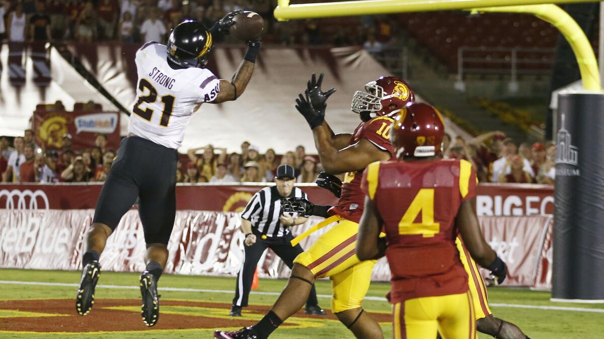 Arizona State's Jaelen Strong catches a 49-yard Hail Mary pass in front of USC's Hayes Pullard to secure the Sun Devils' 38-34 comeback victory over the Trojans last week.