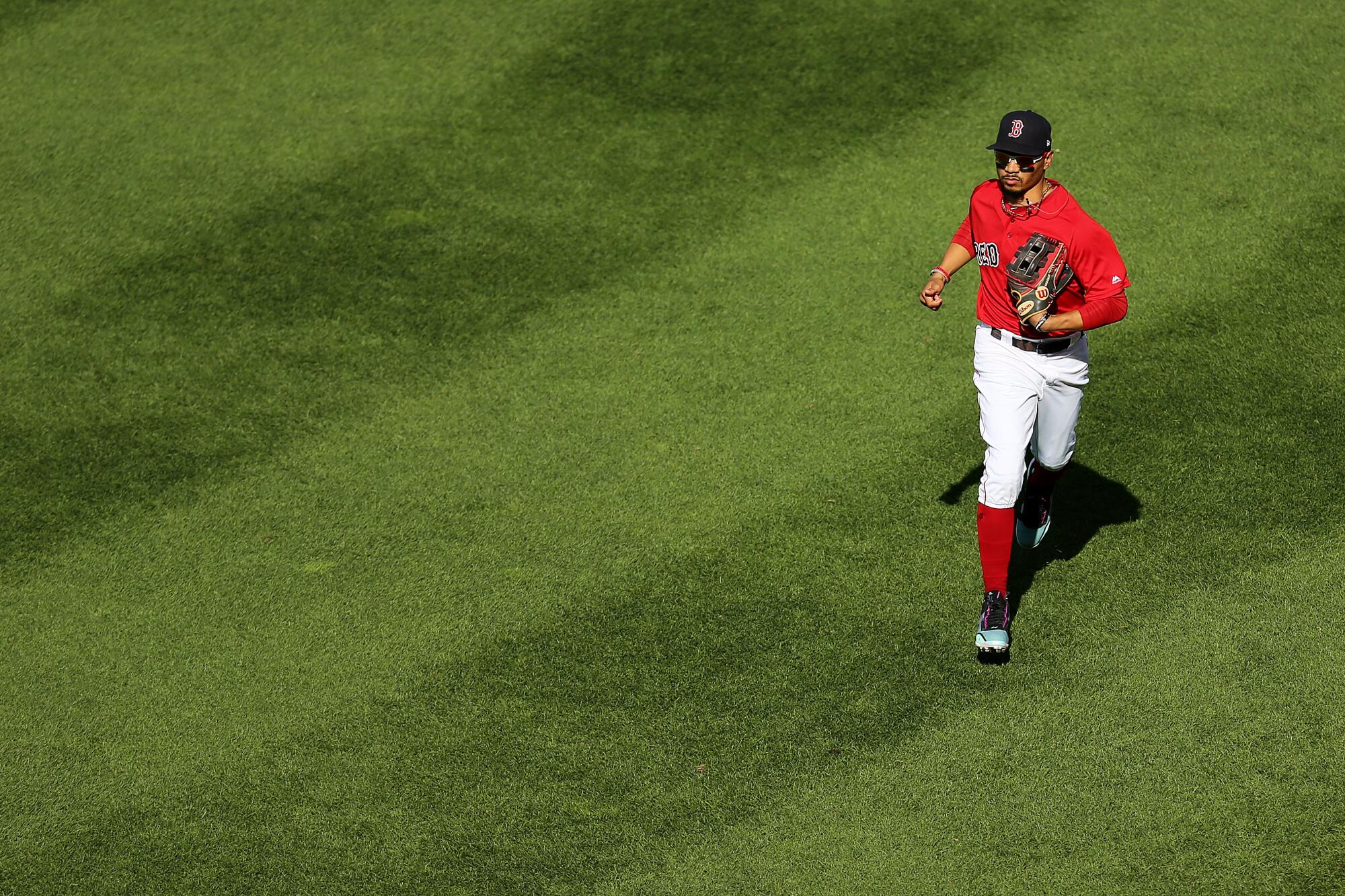 Mookie Betts runs off the field during his final game with the Boston Red Sox on Sept. 29, 2019.