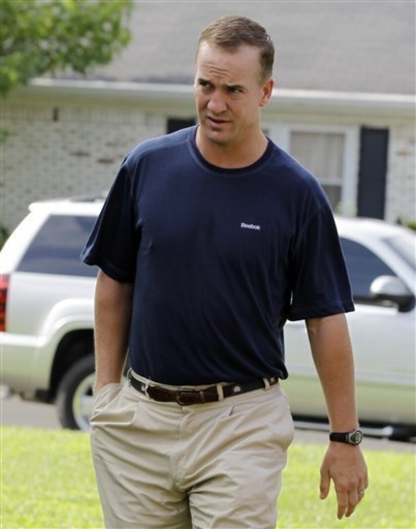 FILE - In this Aug. 1, 2010, file photo, Indianapolis Colts quarterback Peyton Manning walks to a news conference after arriving for the NFL football team's training camp in Anderson, Ind. Manning is from New Orleans but he didn't spend much time there this summer. (AP Photo/Darron Cummings, File)