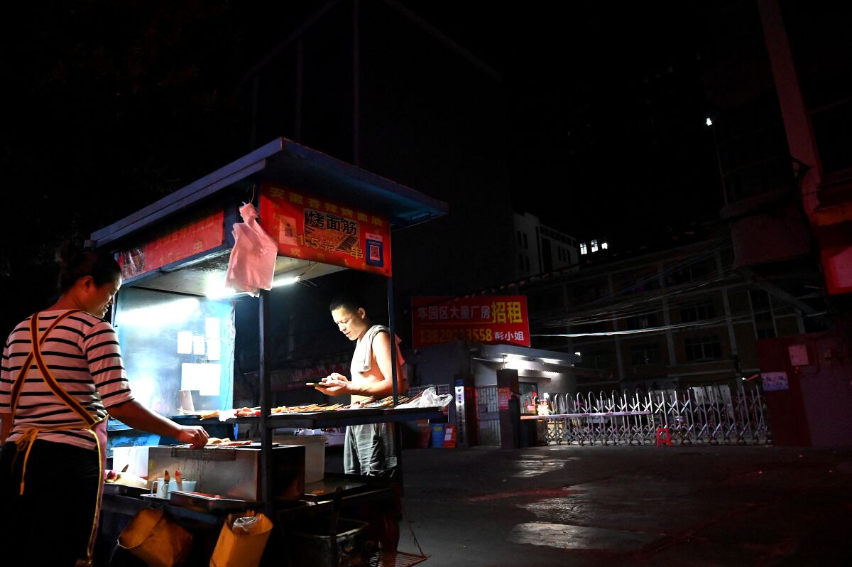 An outdoor barbecue stand at night