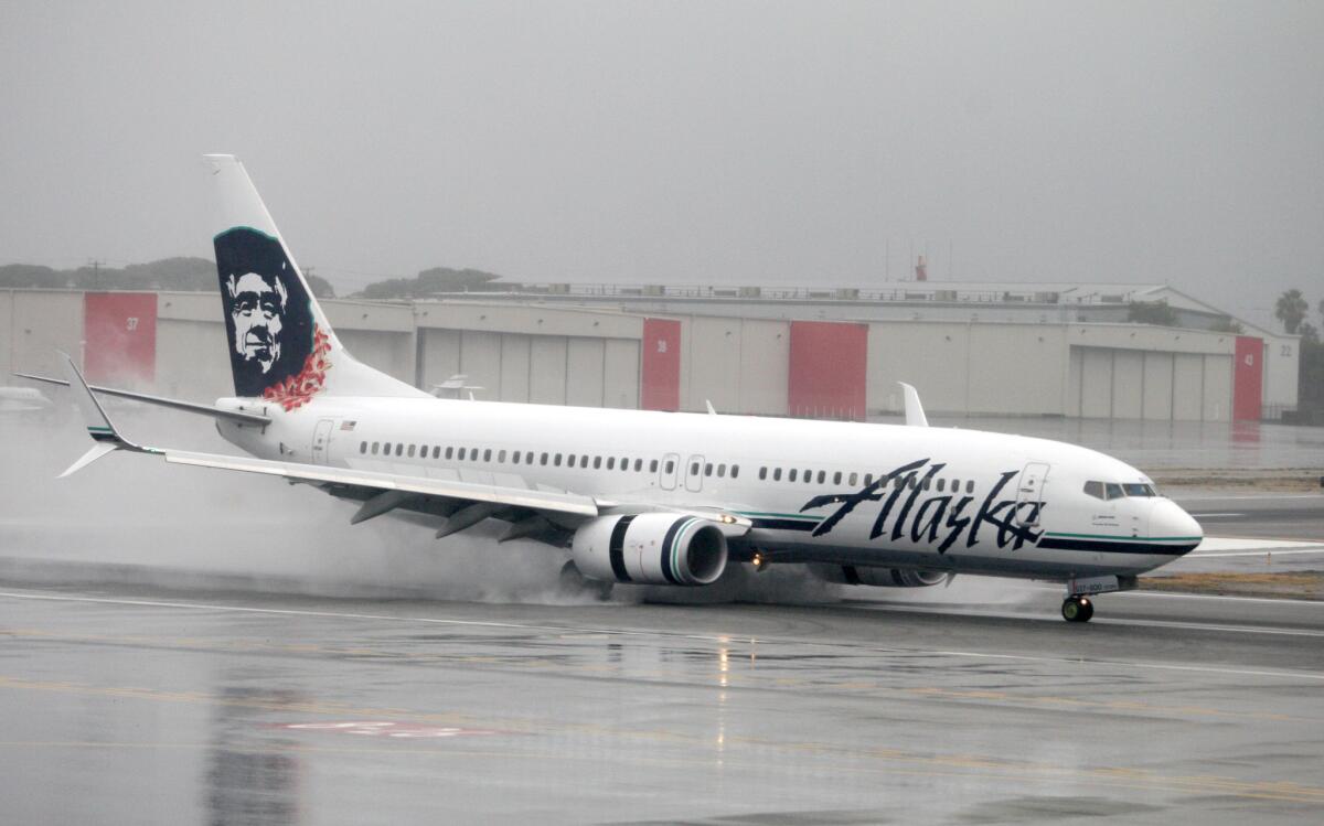 An Alaska Airlines plane arrives under heavy rain at the Bob Hope Airport, in Burbank on Wednesday, Jan. 6, 2016. As of Thursday, the city had received slightly more than 3 inches of rain so far this month, according to the National Weather Service, close to three times as much rain as it saw in all of January 2014. The bulk of the precipitation came on Tuesday and Wednesday.