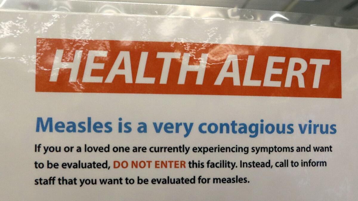 In February, a sign on the door of a medical facility in Seattle warns of measles.