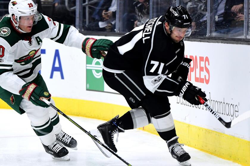 LOS ANGELES, CA - DECEMBER 05: Torrey Mitchell #71 of the Los Angeles Kings keeps the puck from Ryan Suter #20 of the Minnesota Wild during the second period at Staples Center on December 5, 2017 in Los Angeles, California. (Photo by Harry How/Getty Images) ** OUTS - ELSENT, FPG, CM - OUTS * NM, PH, VA if sourced by CT, LA or MoD **