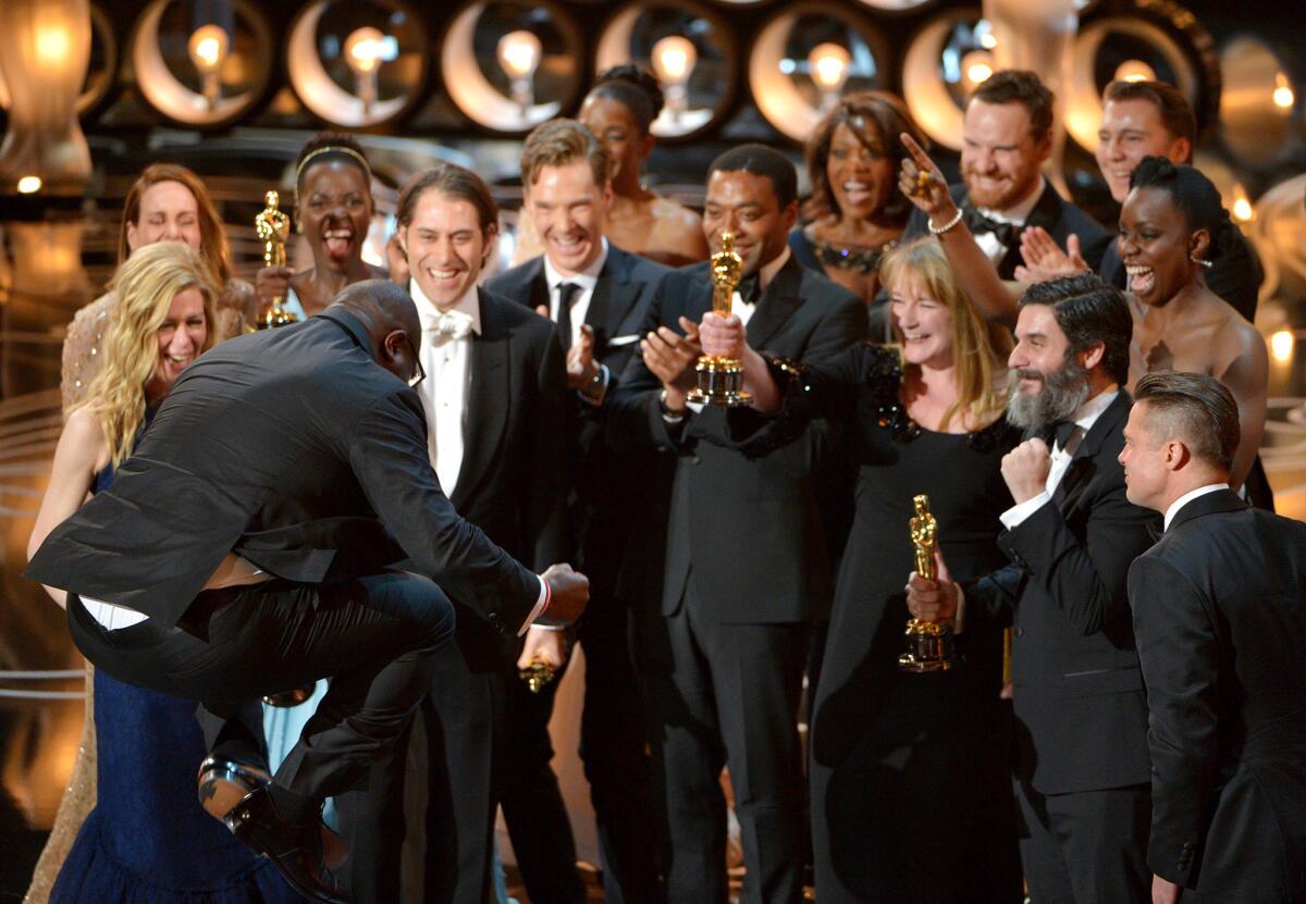 Director Steve McQueen jumps for joy as he and cast and crew members of "12 Years a Slave" accept the award for best picture during the Oscars on Sunday.