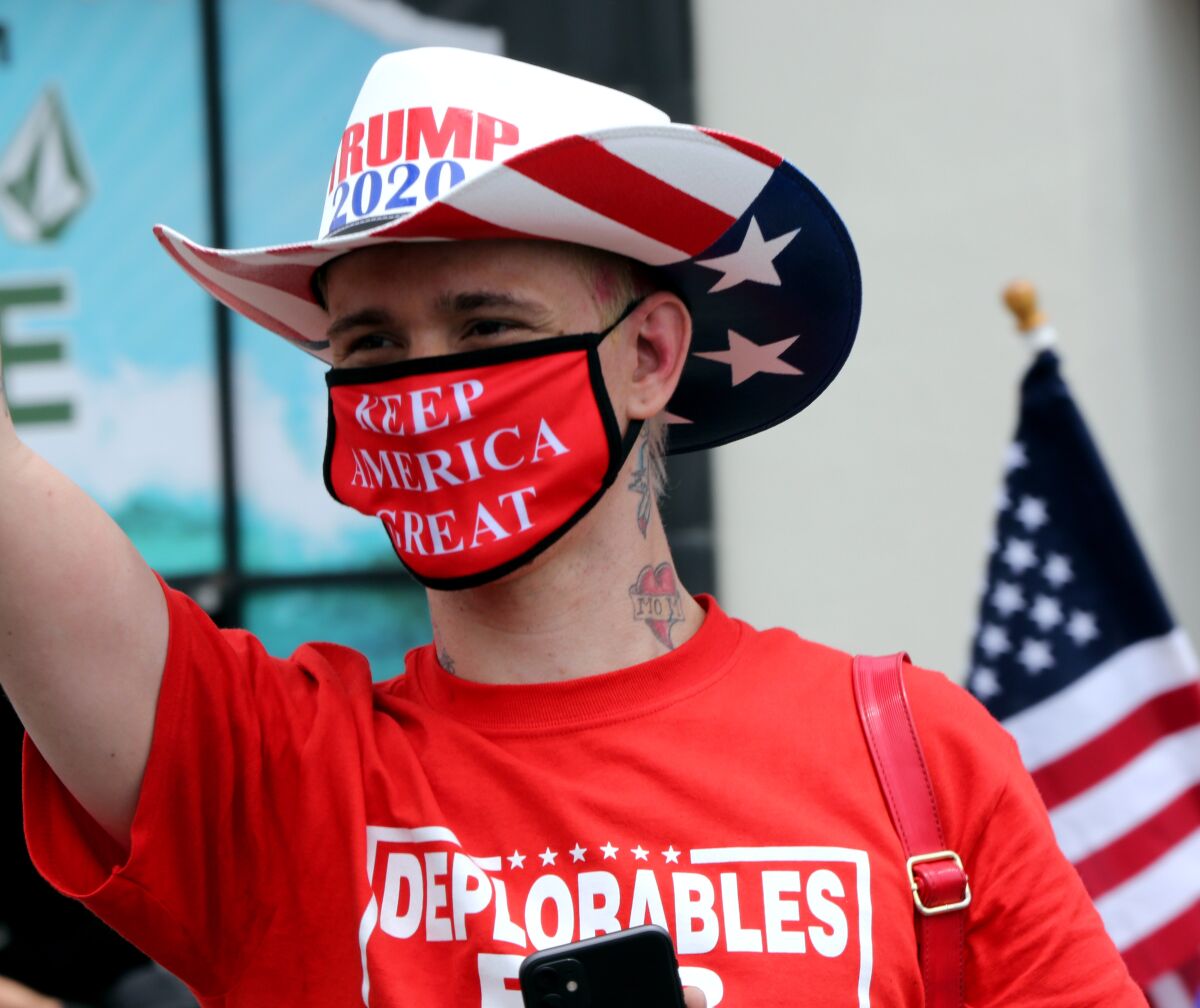 Kristopher Dreww in a Trump cowboy hat, T-shirt that says "Deplorables" and "Keep America great" mask.