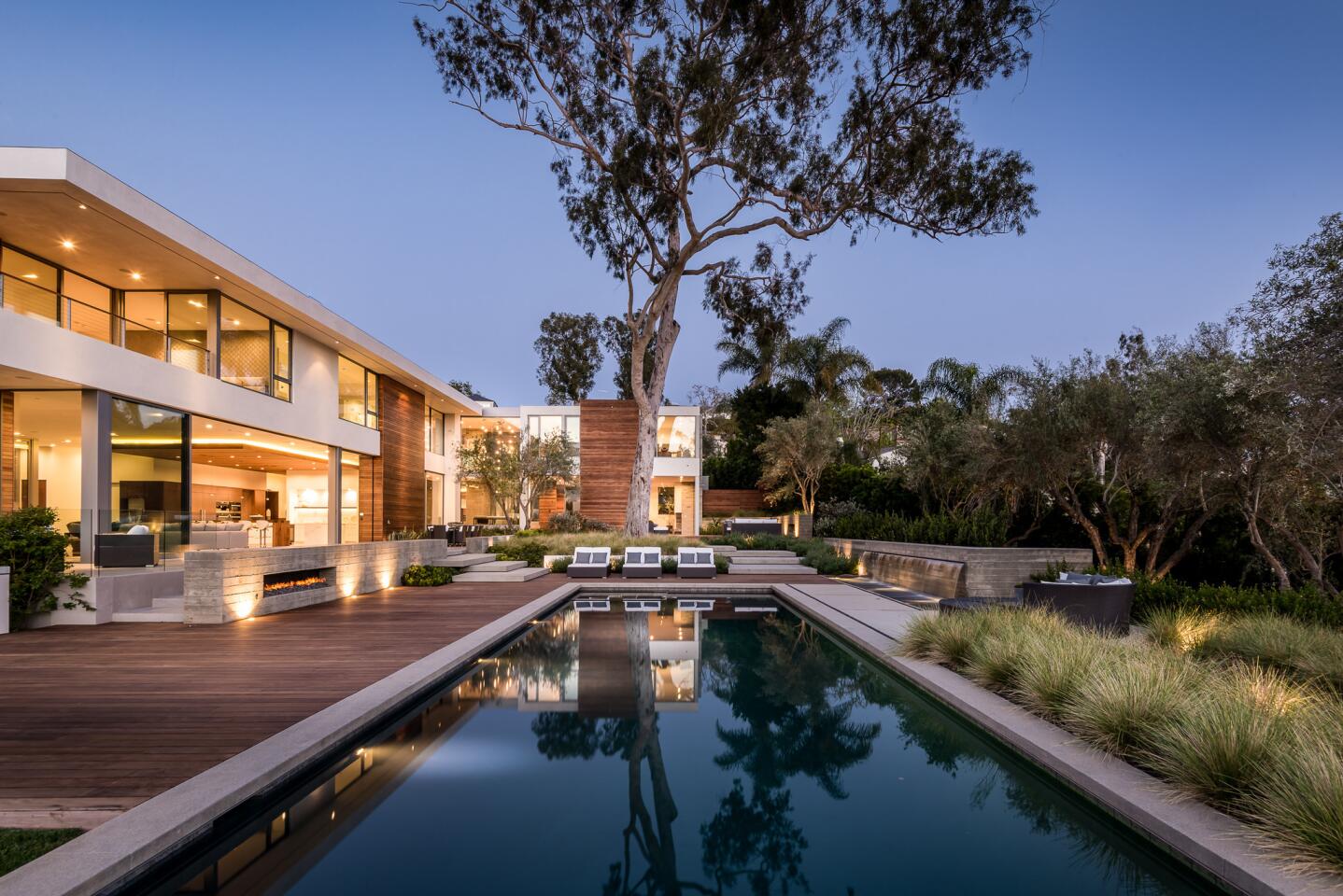 Board-form concrete, expanses of glass and modular shapes form the clean, contemporary shell of this newly built estate in Pacific Palisades. Listed for $26.75 million, the three-story house features nearly 14,000 square feet of living space, eight bedrooms and 12 bathrooms.