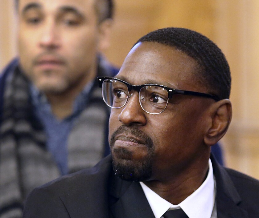 FILE - In this Wednesday, Feb. 14, 2018, file photo, Lamonte McIntyre, convicted of a 1994 double homicide in Kansas City, Kan., sits before the Senate Judiciary Committee where he urged them to approve a bill creating a compensation system in Kansas for people wrongfully convicted of crimes. Kansas is dropping its fight against the compensation claim from McIntyre. Attorney General Derek Schmidt said in an Associated Press interview Tuesday, Feb. 4, 2020, that his office reviewed an additional 900 pages of documents from McIntyre's attorney that had not been provided previously, and also said an ongoing Kansas Bureau of Investigation review of the 1994 crimes for which McIntyre, from Kansas City, Kansas, was charged turned up new information, which his office received only last week. (Thad Allton/The Topeka Capital-Journal via AP, File)