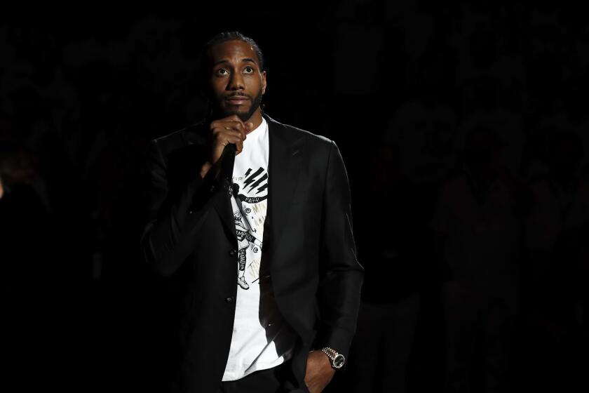 Former San Diego State forward Kawhi Leonard, now with the Los Angeles Clippers, speaks as part of a ceremony to retire his number 15 jersey during halftime of an NCAA college basketball game against Utah State, Saturday, Feb. 1, 2020, in San Diego. (AP Photo/Gregory Bull)