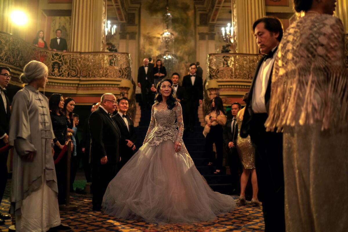 An Asian woman (Michelle Yeoh) attends a lavish event in a fancy gown in EVERYTHING EVERYWHERE ALL AT ONCE