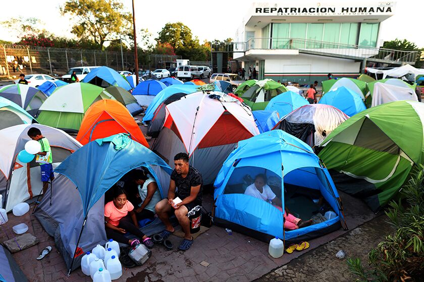 Migrants from Central America and Mexico await the outcome of their U.S. immigration court cases in a tent encampment near the Gateway International Bridge at the U.S.-Mexico border in Matamoros, Tamaulipas, in 2019.