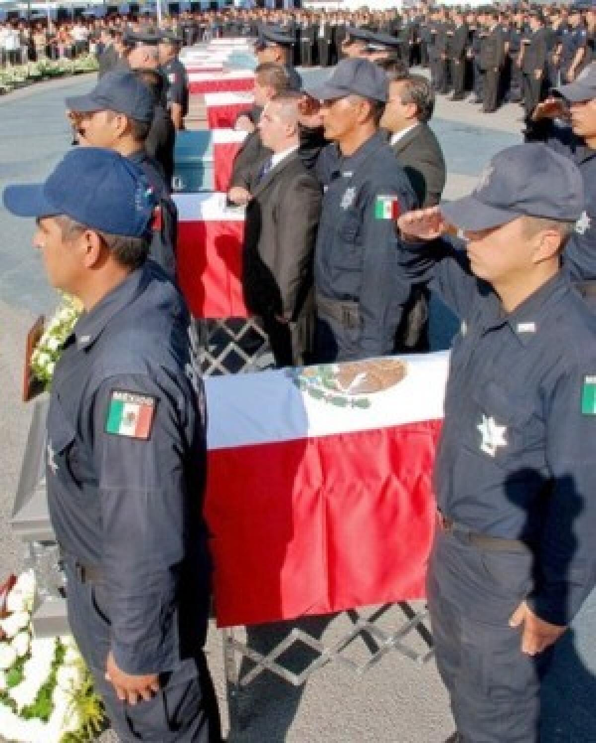 Federal police participate this week in the Mexico City funeral for 12 fellow officers whose bodies were found in a heap in the western state of Michoacan. The La Familia drug gang is suspected of killing them.