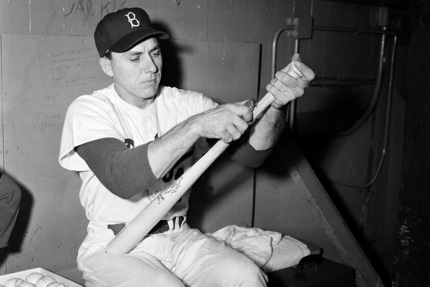 Brooklyn Dodgers' first baseman Gil Hodges shaves a new bat in New York, Oct. 1, 1952. (AP Photo/Dan Grossi)