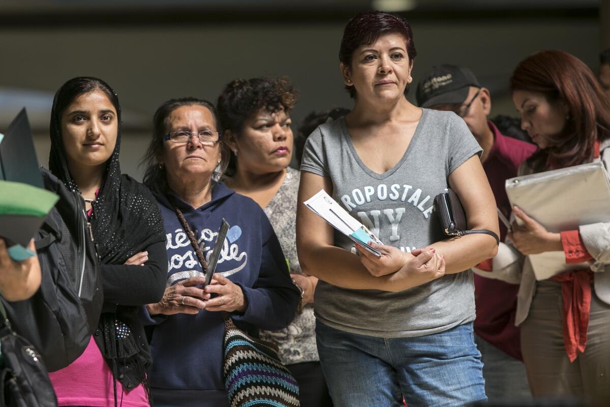 A line forms at Panorama Mall on Friday as people sign up for healthcare coverage at a Covered California enrollment event, ahead of Monday's deadline for Obamacare enrollment.