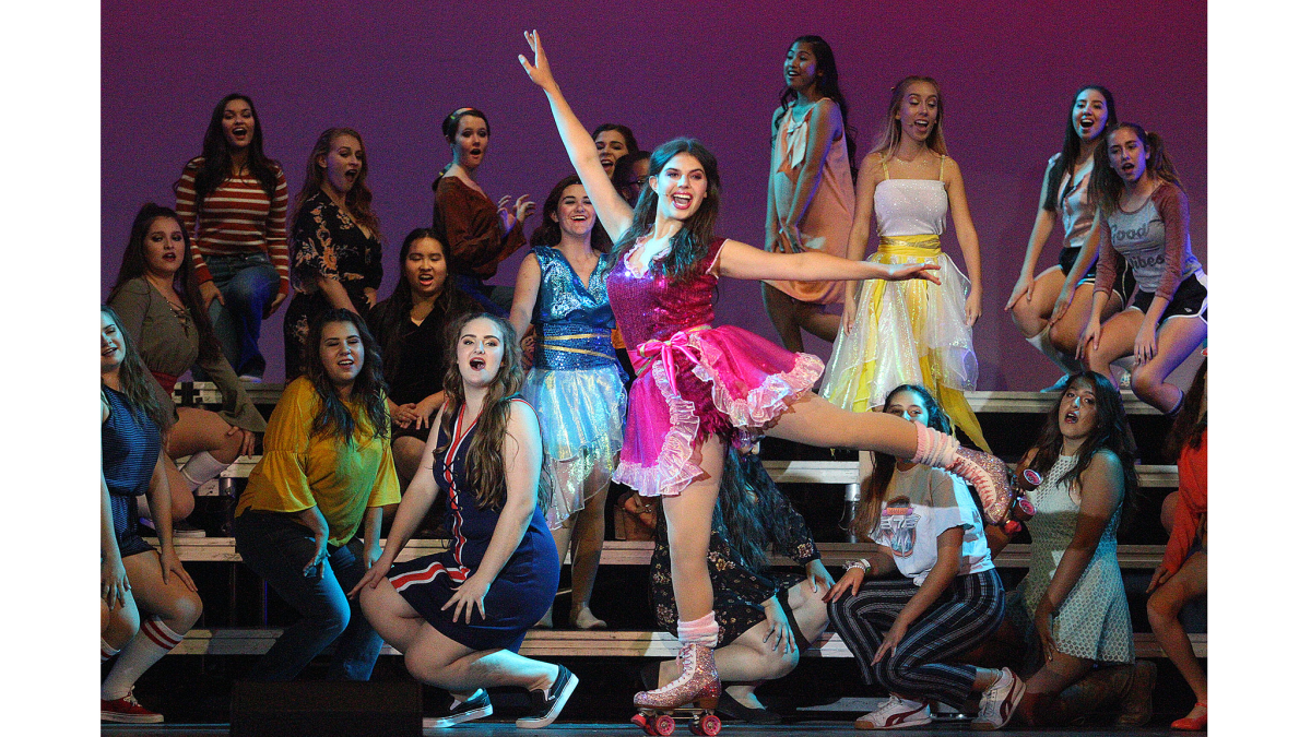 Maddy Mahay skates across the stage at rehearsal for "Xanadu," at Burroughs High on Tuesday.
