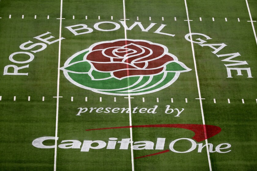 FILE - The Rose Bowl Game logo is displayed on the field at AT&T Stadium before the Rose Bowl NCAA college football game between Notre Dame and Alabama in Arlington, Texas, on Jan. 1, 2021. A study by The Institute for Diversity and Ethics in Sport (TIDES) at Central Florida reported that the overall Graduation Success Rate (GSR) for bowl-bound teams had increased to 81.3%, up from 78% for 2020. Yet the racial gap fell as the average GSR for Black athletes rose from 73.4% in 2020 to 78% this year while white athletes remained steady at 89.7%. (AP Photo/Roger Steinman, File)