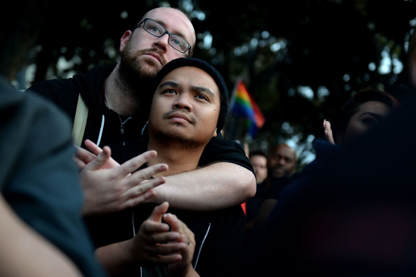 Scott Phillips and Em Enagan mourn for the 49 lives lost in the Orlando shooting during a vigil at Los Angeles City Hall.