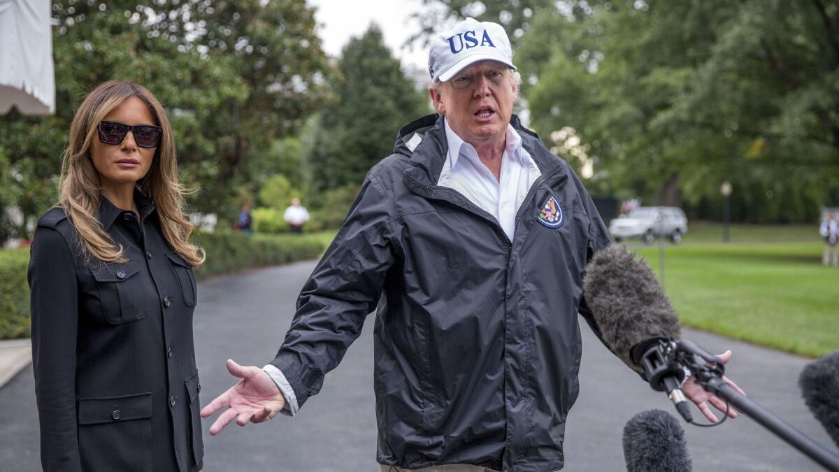 President Trump, shown with First Lady Melania Trump, speaks about his negotiations with Democrats on DACA before leaving to inspect hurricane-hit Florida.