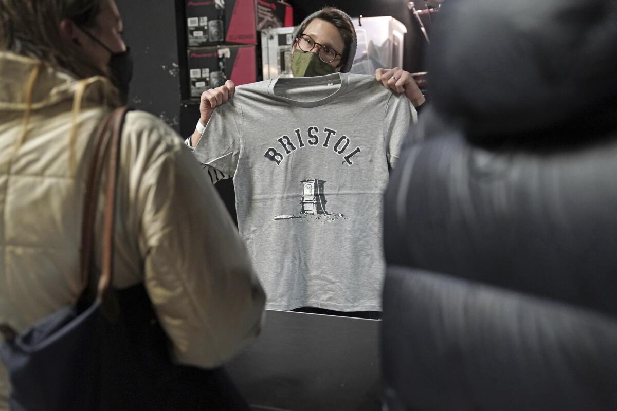 A T-shirt designed by street artist Banksy is displayed at a store in Bristol, England, on Saturday.