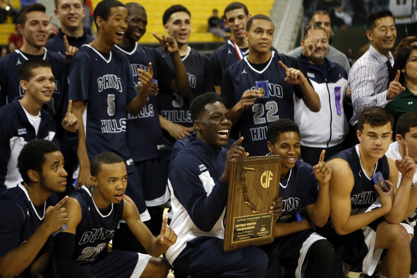 Chino Hills players are all smiles after defeating Centennial in the Division I Southern California Regional basketball final at Long Beach State on Saturday.