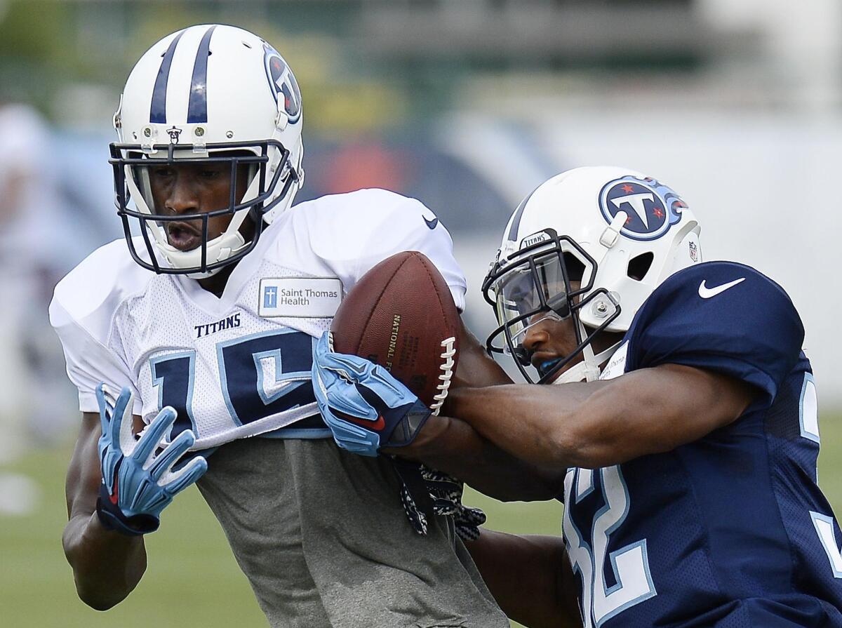 Tennessee Titans cornerback and Mr. Irrelevant Kalan Reed, right, who breaks up a pass intended for wide receiver Justin Hunter, was cut by the team.