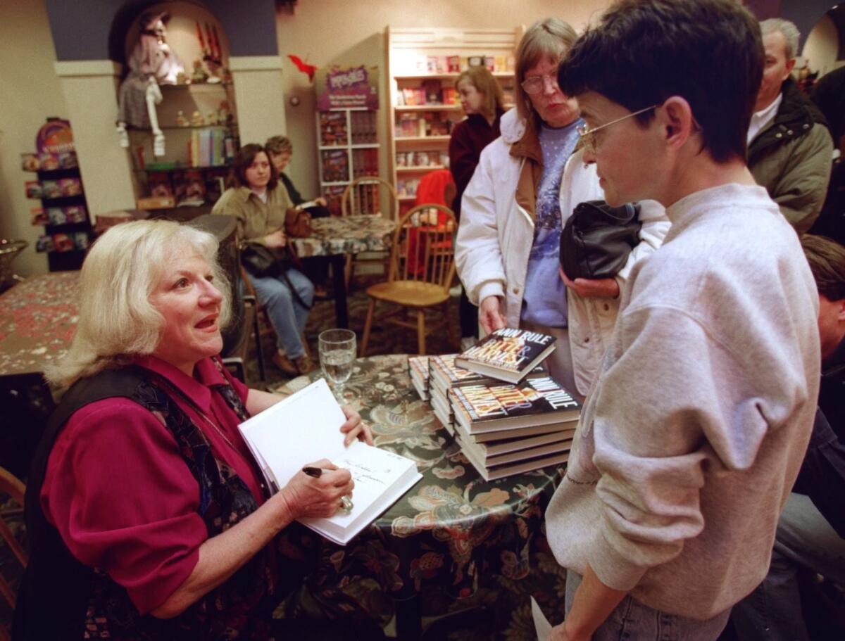 True-crime writer Ann Rule signing copies of her book in 1998.